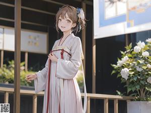 A woman in a white kimono is posing on a bed.