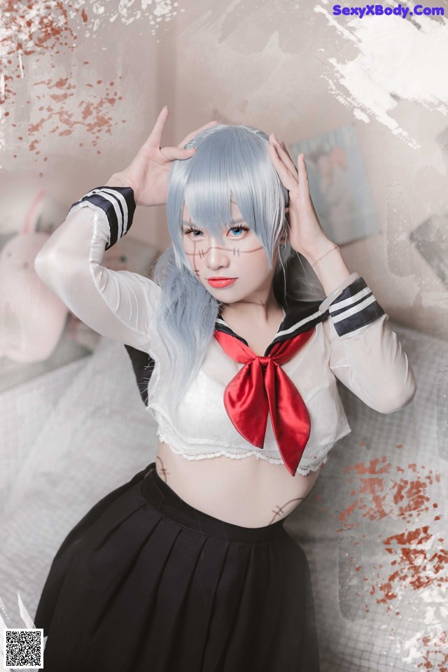 A woman in a sailor outfit posing for a picture.