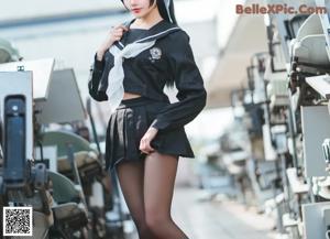 A woman in a school uniform is posing for a picture.