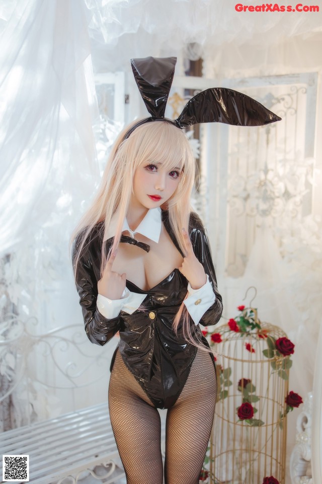 A woman in a bunny costume posing for a picture.
