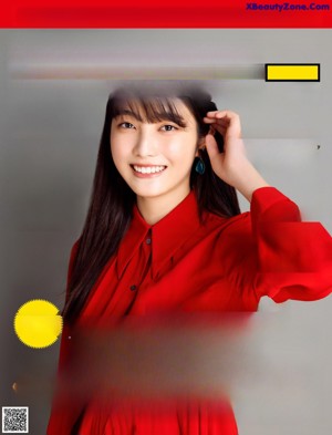 A woman with long black hair wearing a red shirt.