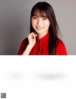 A woman in a red jacket is looking at the camera.
