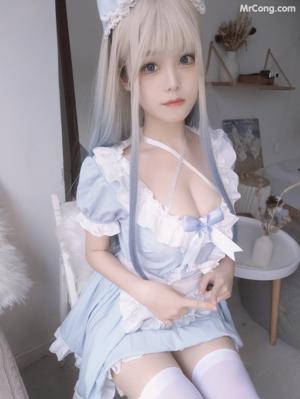 a woman in a white lingerie sitting on a chair