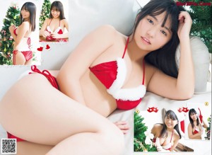 A woman in a santa hat sitting next to a christmas tree.