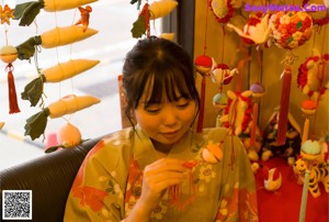 A woman in a kimono is posing for the camera.