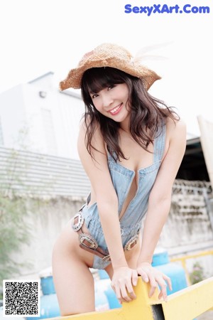 A woman in a purple bikini posing for a magazine.