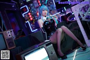 A woman in bunny ears sitting on top of a table.