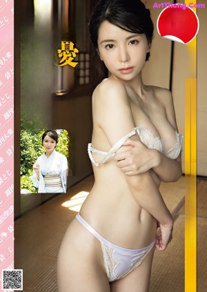A woman in a white lingerie laying on a bed.