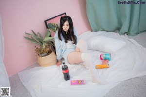 A woman sitting on a chair eating a piece of food.